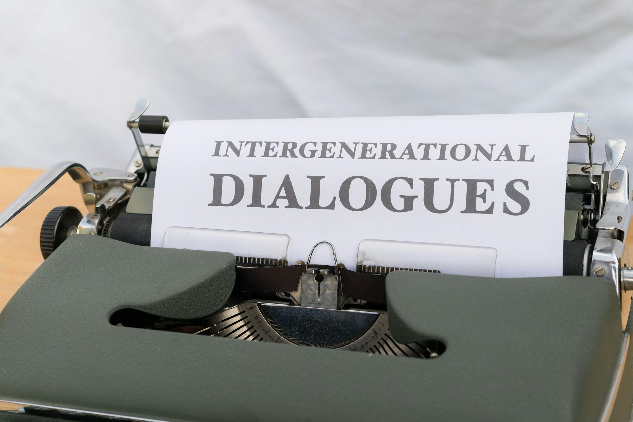 Close-up of a vintage typewriter with a sheet labeled 'Intergenerational Dialogues.'